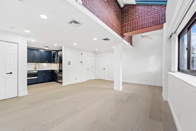 a view of a hallway with a kitchen