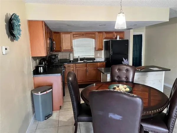 a dining room with furniture a window and appliances