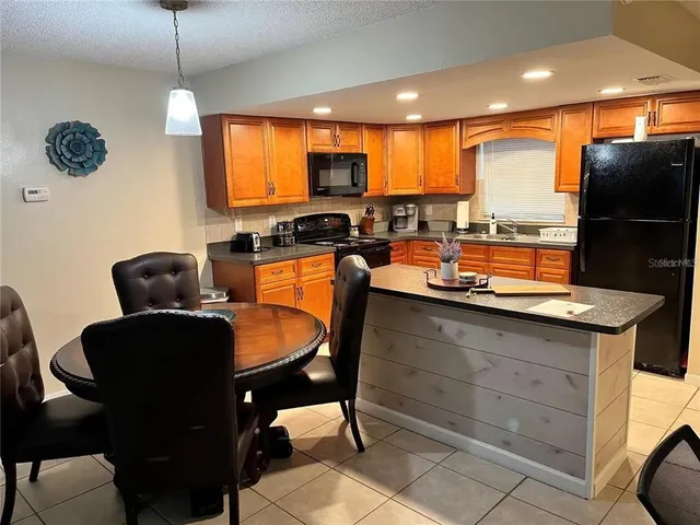 a dining room with furniture and a flat screen tv