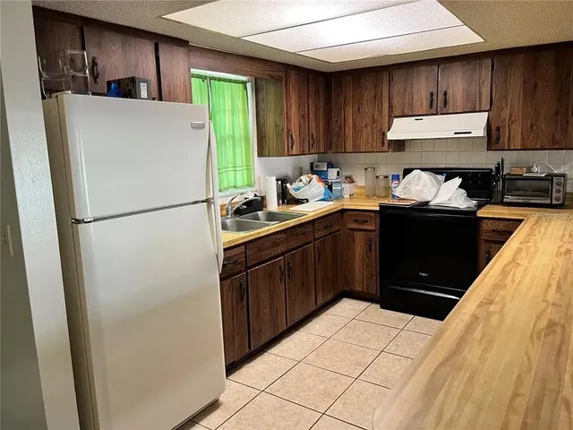 a kitchen with a refrigerator and a sink