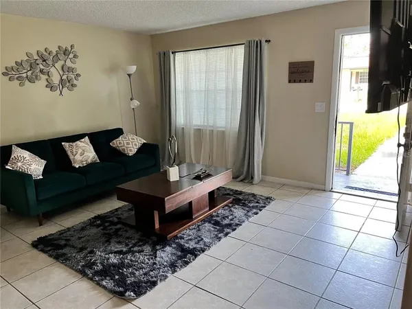 a living room with furniture and a table