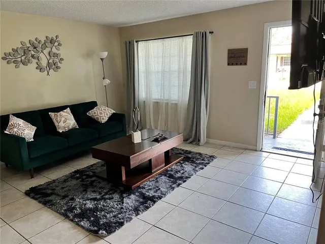a living room with furniture and a table