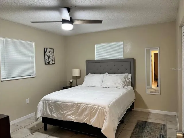 a bedroom with a bed and a lamp