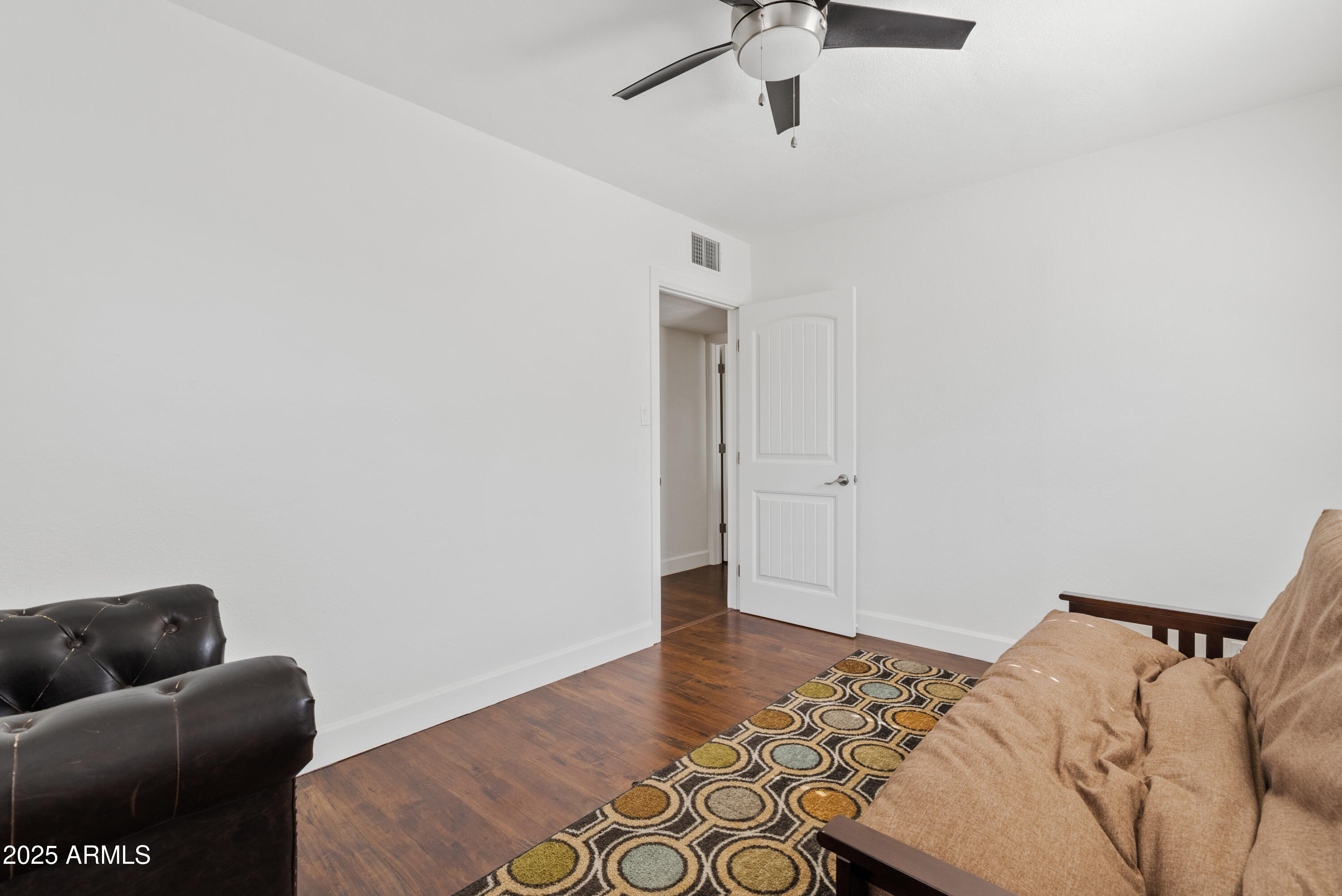 1704 West Roma Avenue Phoenix, AZ 85015 - Photo 17 of 21 a bedroom with a bed and a couch
