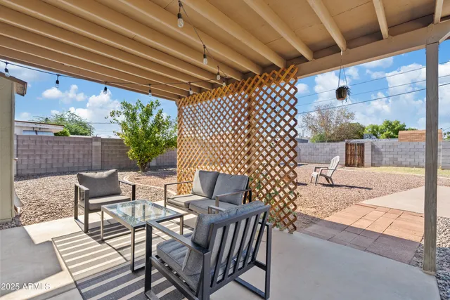 a view of a house with backyard and sitting area