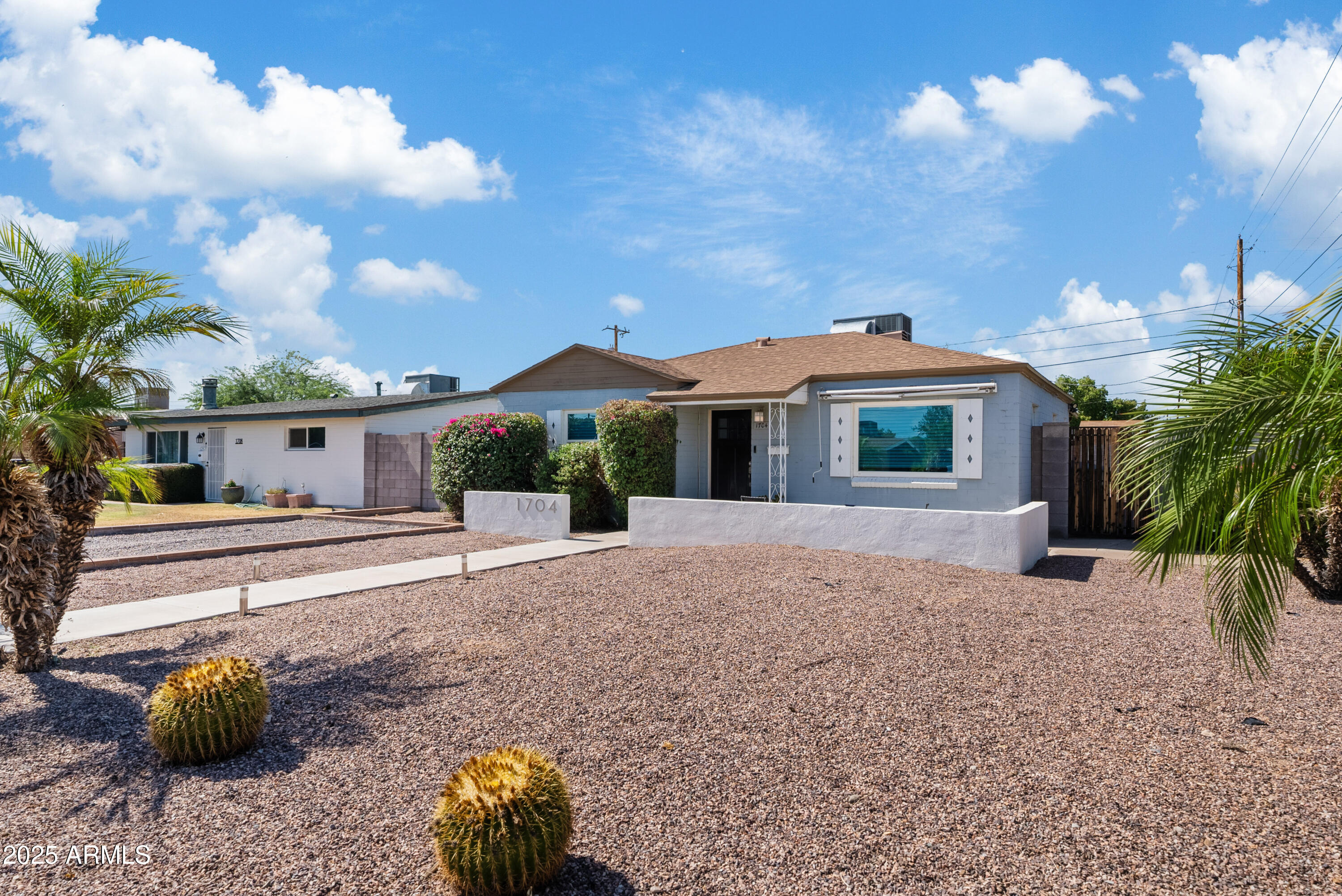 1704 West Roma Avenue Phoenix, AZ 85015 - Photo 2 of 21 a front view of a house with a yard and a garage