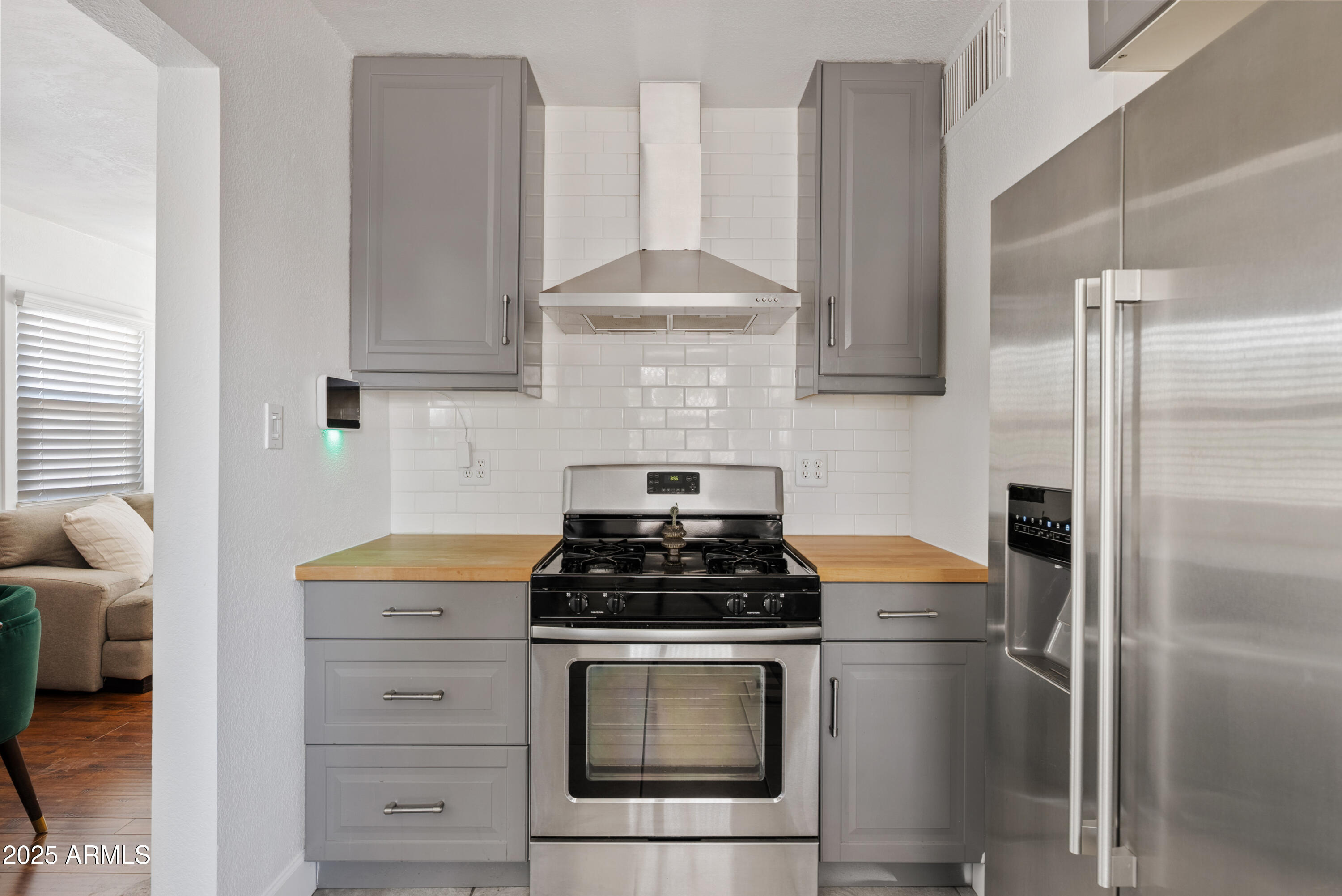 1704 West Roma Avenue Phoenix, AZ 85015 - Photo 8 of 21 a kitchen with stainless steel appliances a stove a refrigerator and cabinets