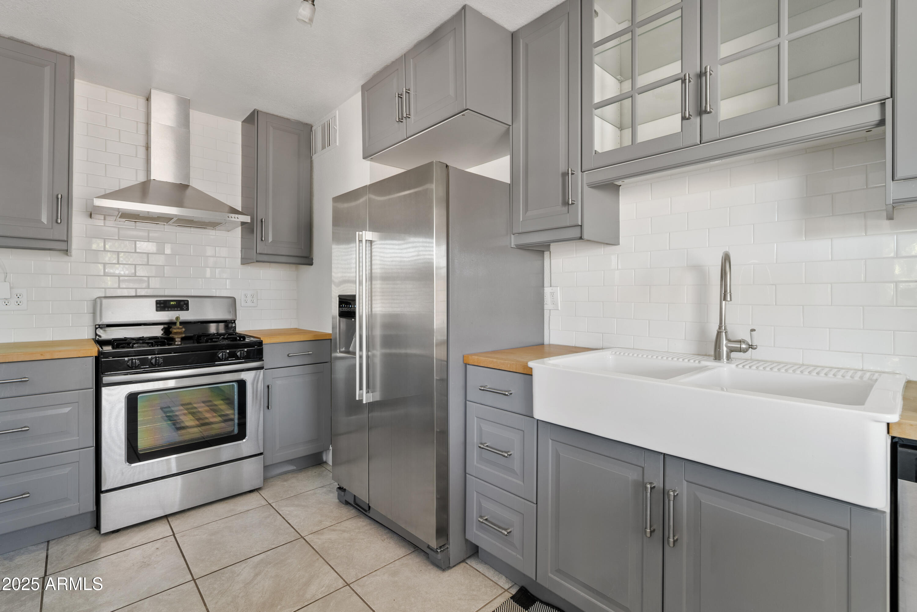 1704 West Roma Avenue Phoenix, AZ 85015 - Photo 9 of 21 a kitchen with stainless steel appliances granite countertop a sink a stove a refrigerator and cabinets