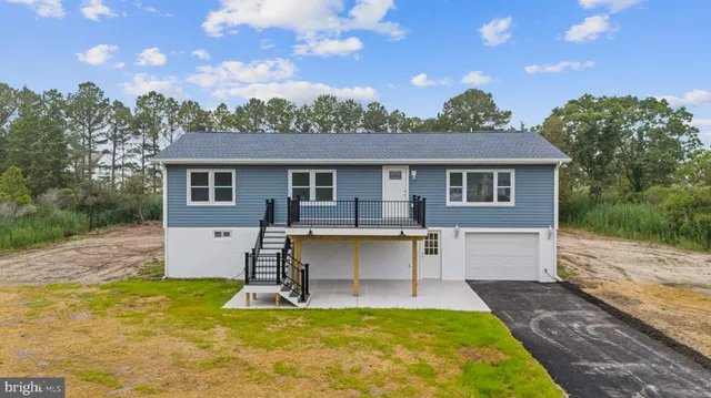 a view of a house with pool and a yard