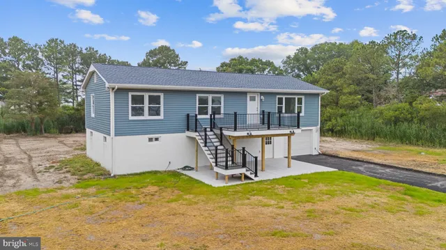 a view of a house with pool and chairs