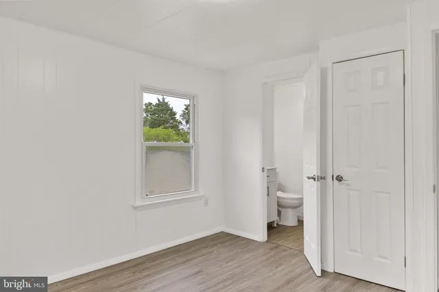 a view of a room with wooden floor and windows