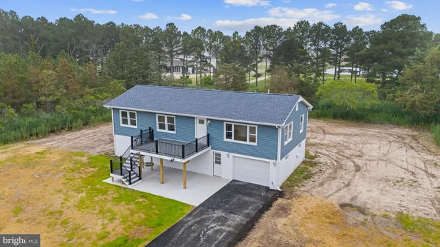 a aerial view of a house with a yard table and chairs