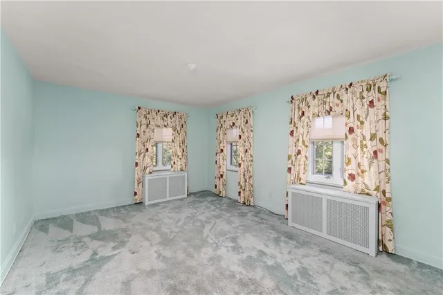 a view of room with a ceiling fan and a window