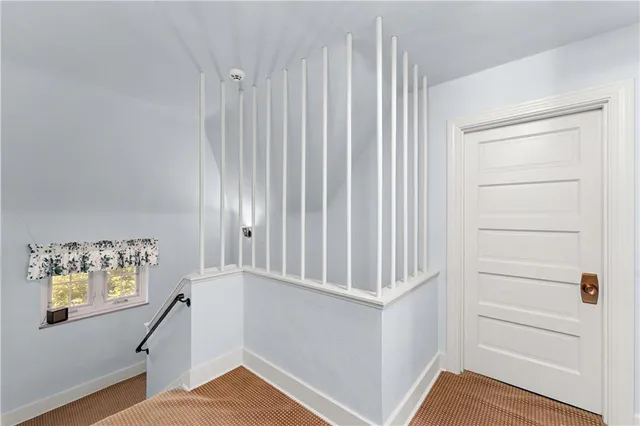 a front view of a house with yard and green space