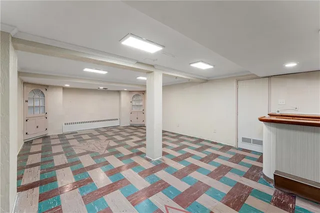 a view of a house next to a big yard and large trees