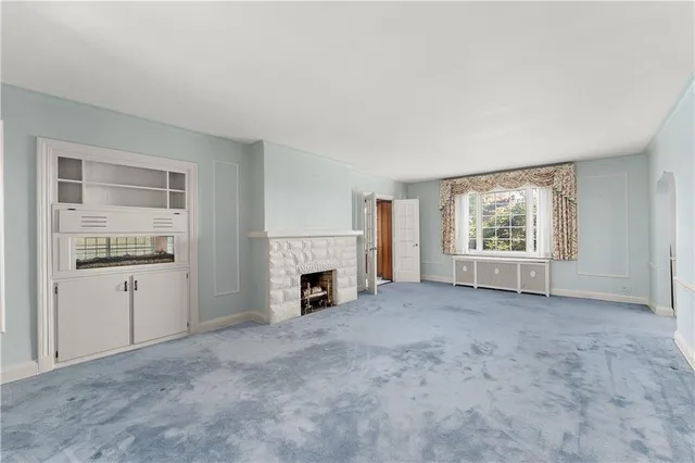 a view of empty room with a fireplace