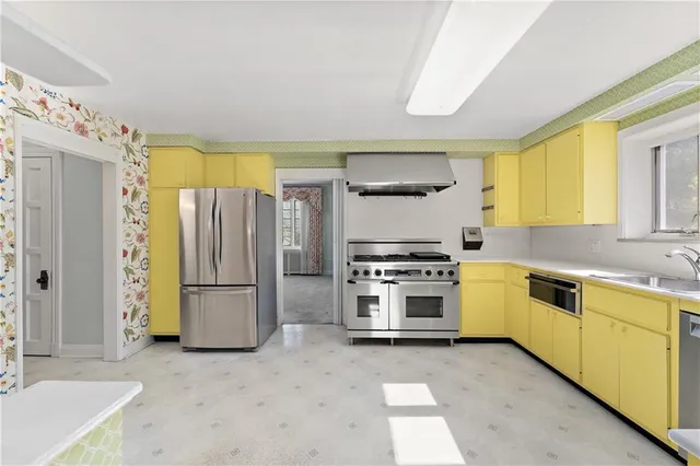 a kitchen with appliances cabinets and a sink