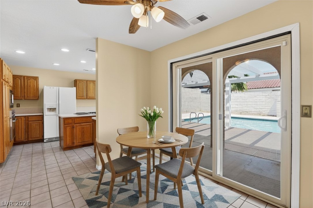 3698 Laughlin Boulevard Laughlin, NV 89029 - Photo 24 of 49 A well-lit kitchen with natural wood cabinetry opens to a private pool area through sliding glass doors.