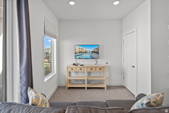 1122 South 1790th West, Unit 1 St. George, UT 84770 - Photo 21 of 37 Recessed ceiling lighting illuminates a carpeted interior space with a window offering natural light