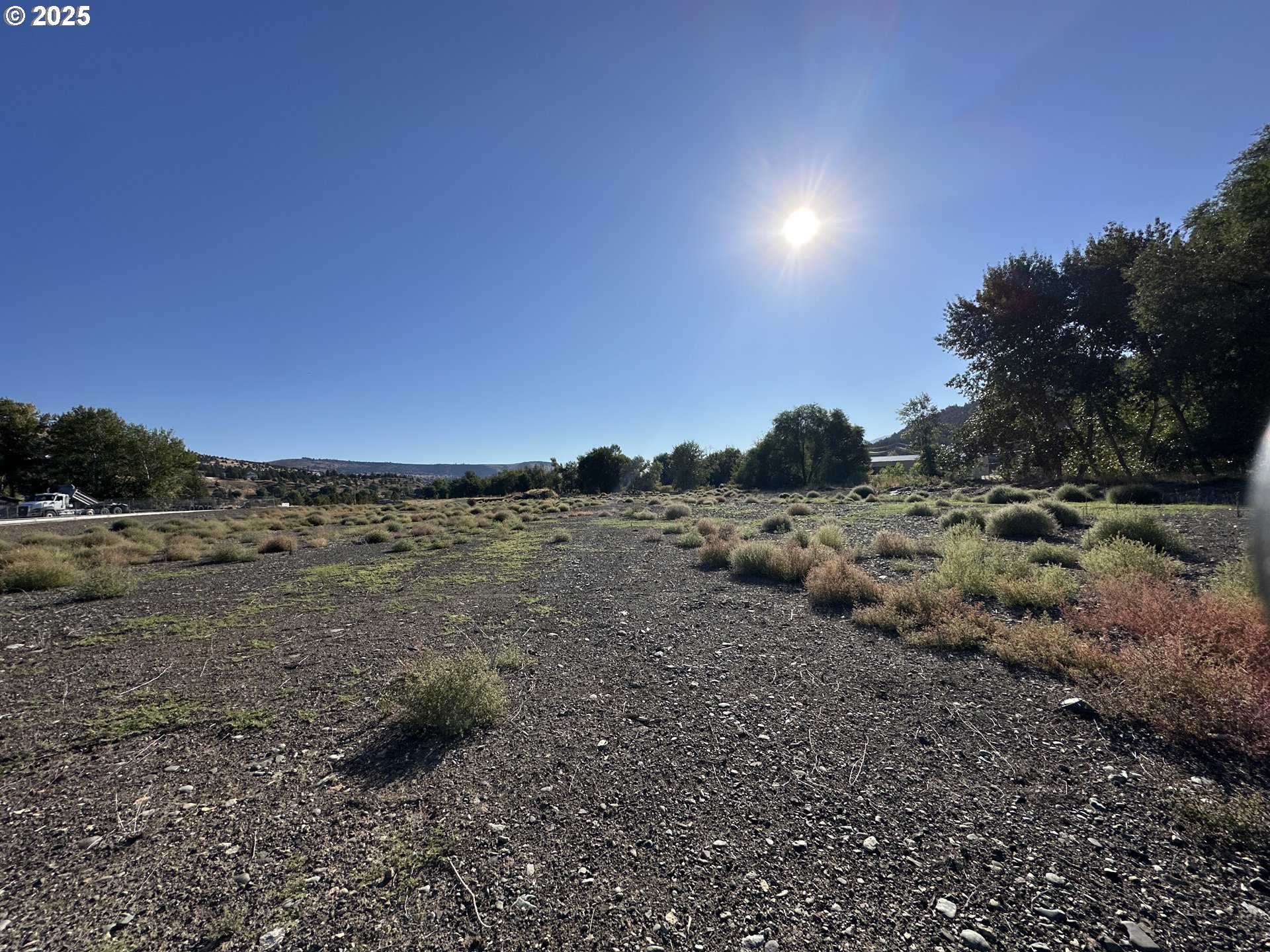 St-johnday Northeast 7th Street John Day, OR 97845 - Photo 6 of 33 a view of a dirt road and mountain view