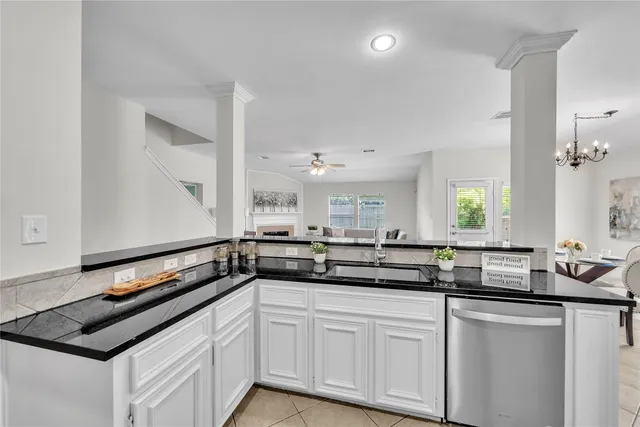 a kitchen with granite countertop a refrigerator and a sink