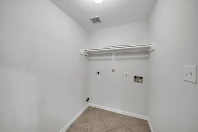a dining room with furniture a chandelier and window