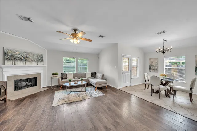 a living room with furniture a fireplace and a window