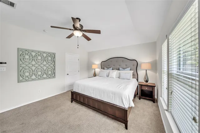 a large bed sitting in a room next to a window