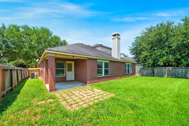 a front view of a house with a garden and yard