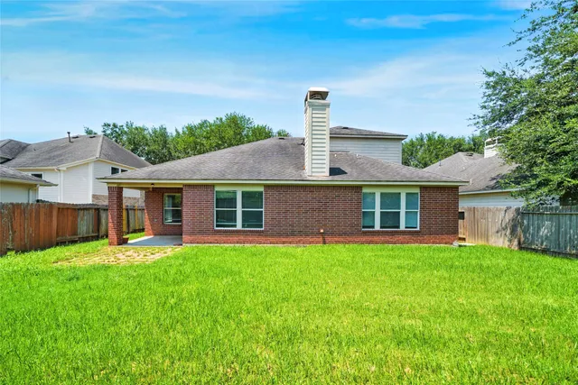 an aerial view of residential houses with outdoor space and lake view