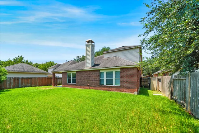 an aerial view of a house with a yard and lake view