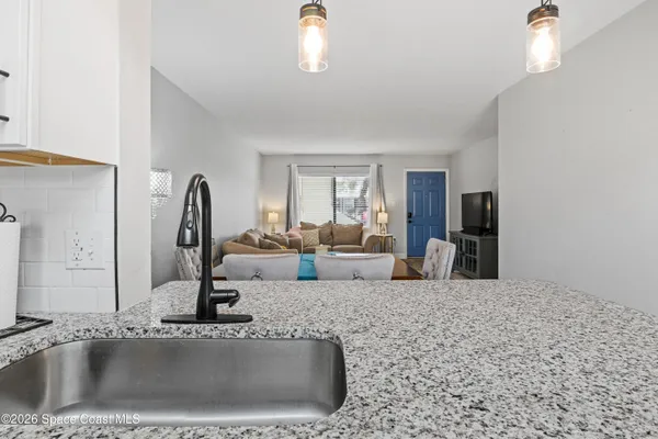 a view of a kitchen counter top and living room