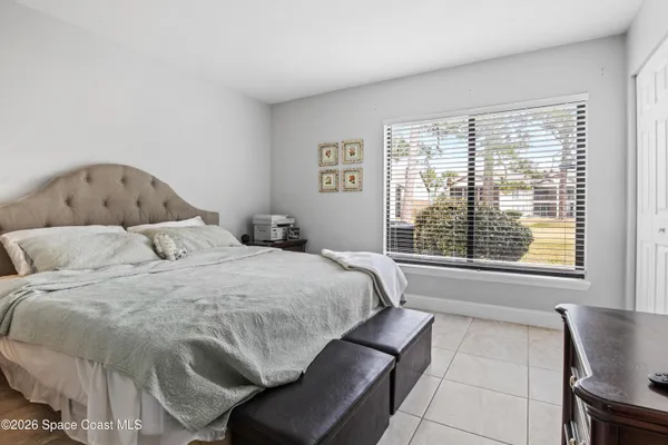 a bedroom with a bed and window