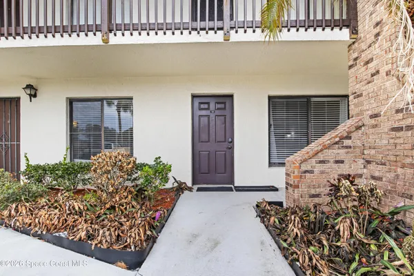 front view of a house with a potted plant