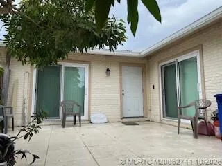 a couple of potted plants in front of door