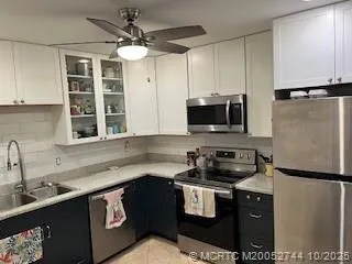 a kitchen with a sink a stove and a refrigerator