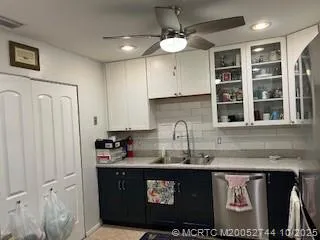 a kitchen with stainless steel appliances granite countertop a sink a stove and a microwave