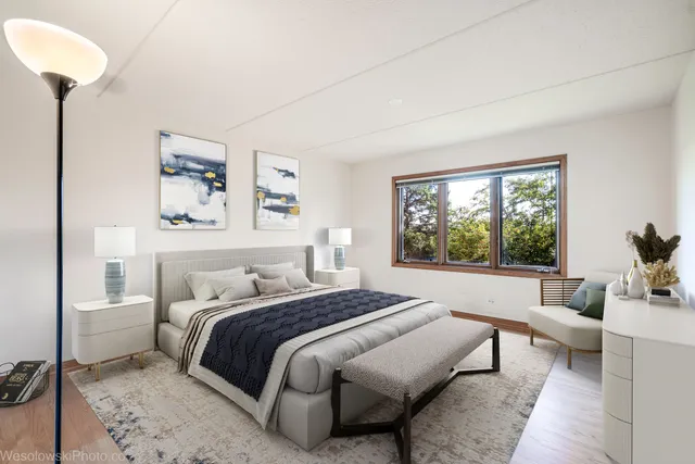 a bedroom with a large bed and a window