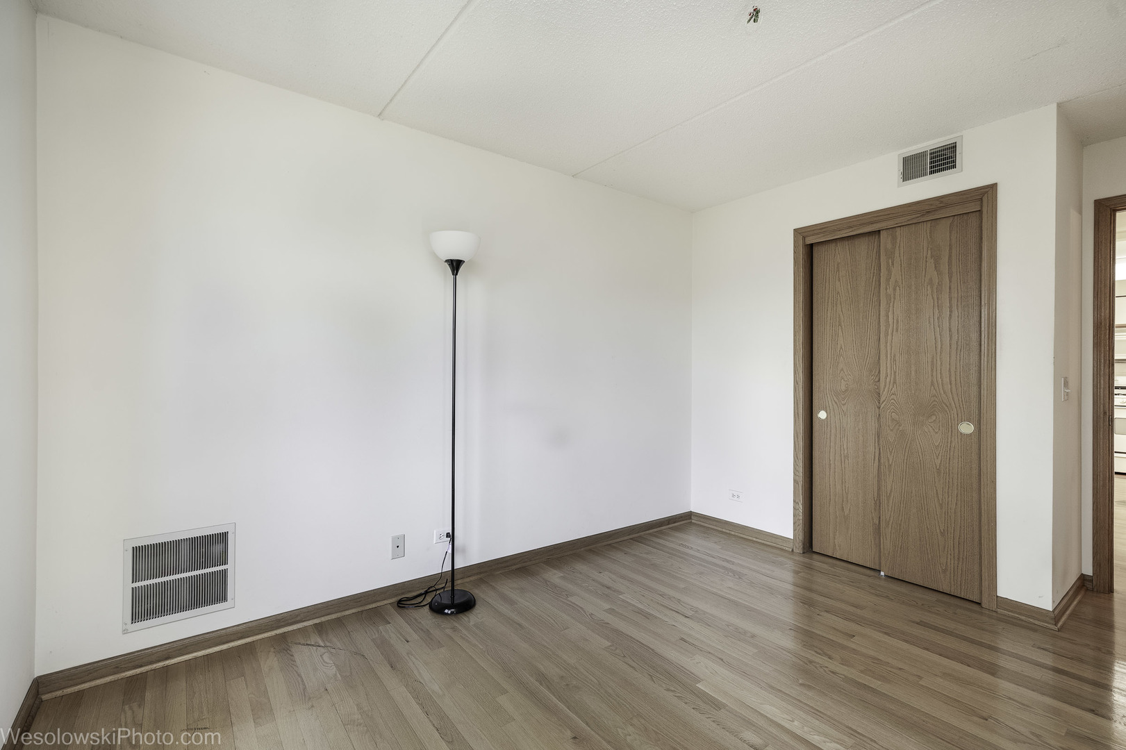 7450 Waukegan Road, Unit 206 Niles, IL 60714 - Photo 13 of 26 a view of an empty room with wooden floor