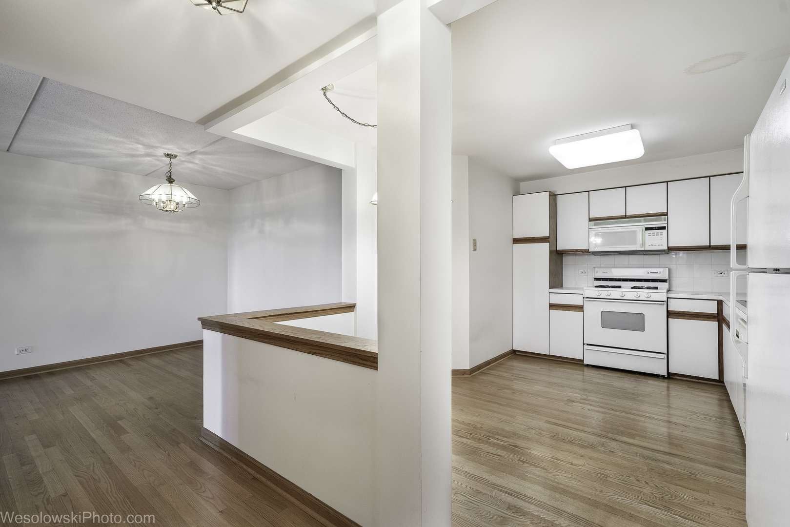 7450 Waukegan Road, Unit 206 Niles, IL 60714 - Photo 15 of 26 a kitchen with granite countertop white cabinets and white appliances