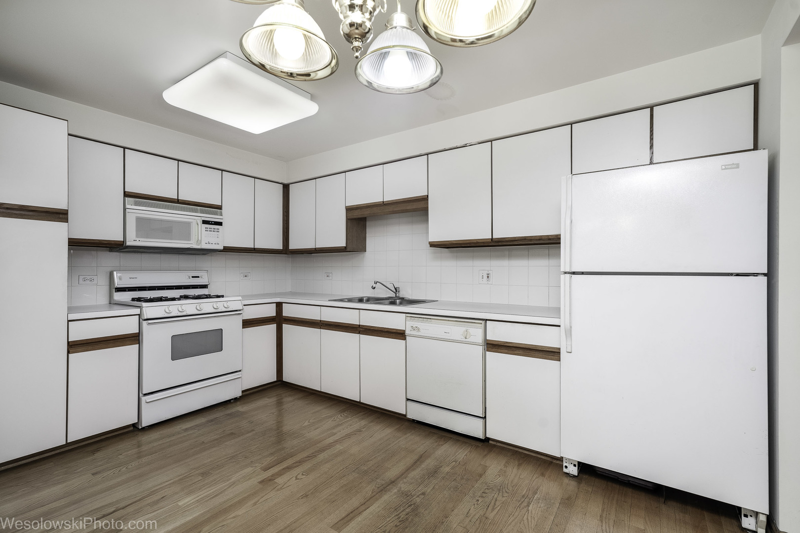 7450 Waukegan Road, Unit 206 Niles, IL 60714 - Photo 18 of 26 a kitchen with stainless steel appliances granite countertop a sink a stove a refrigerator and cabinets