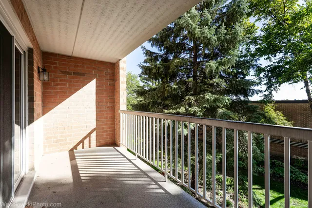 a view of balcony with wooden floor and fence
