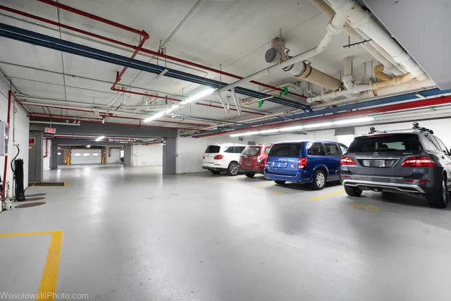 a view of a cars park in front of a building