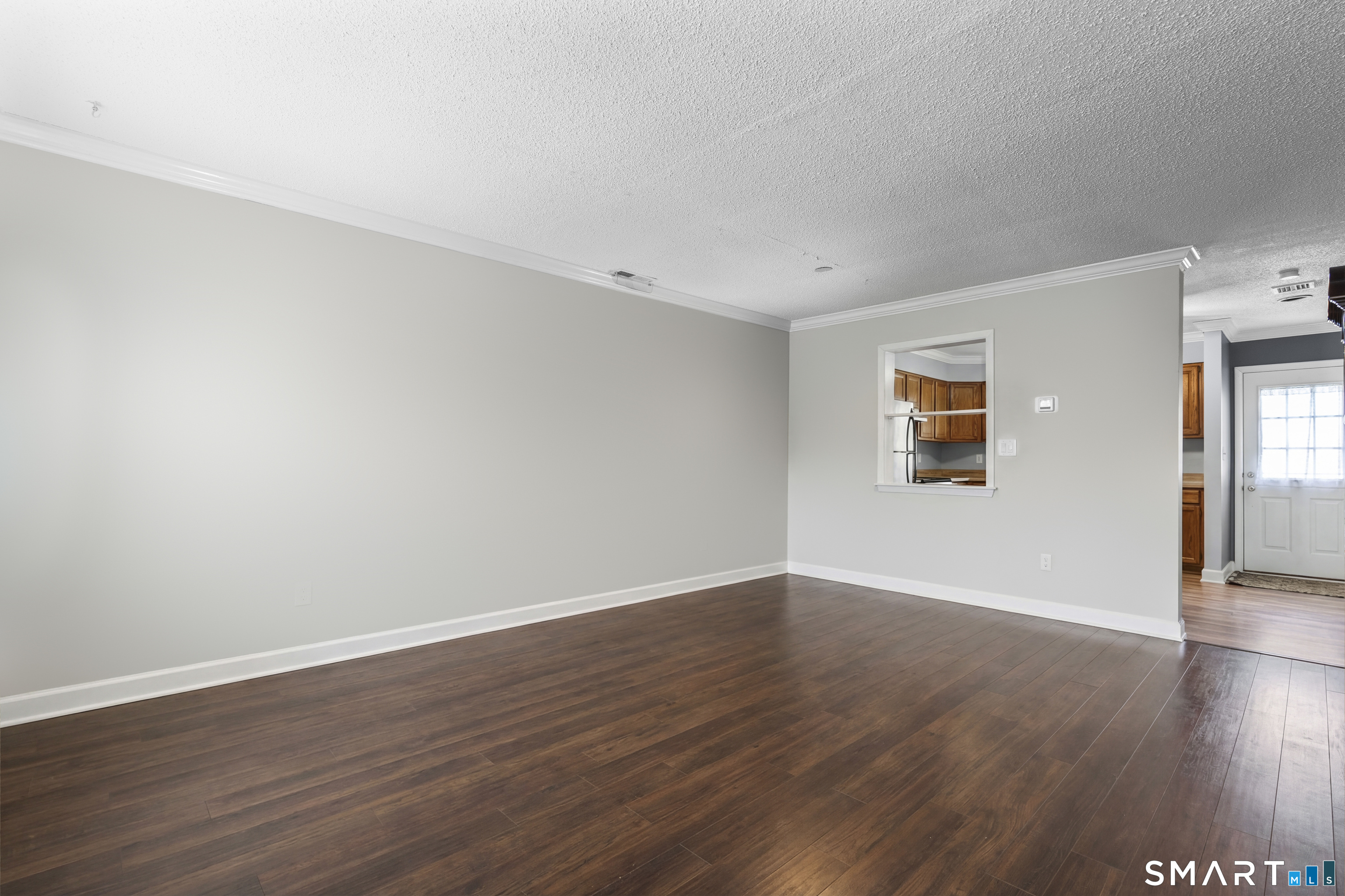 3 MacIntosh Lane, Unit 3 Ansonia, CT 06401 - Photo 12 of 34 a view of an empty room with wooden floor and a window
