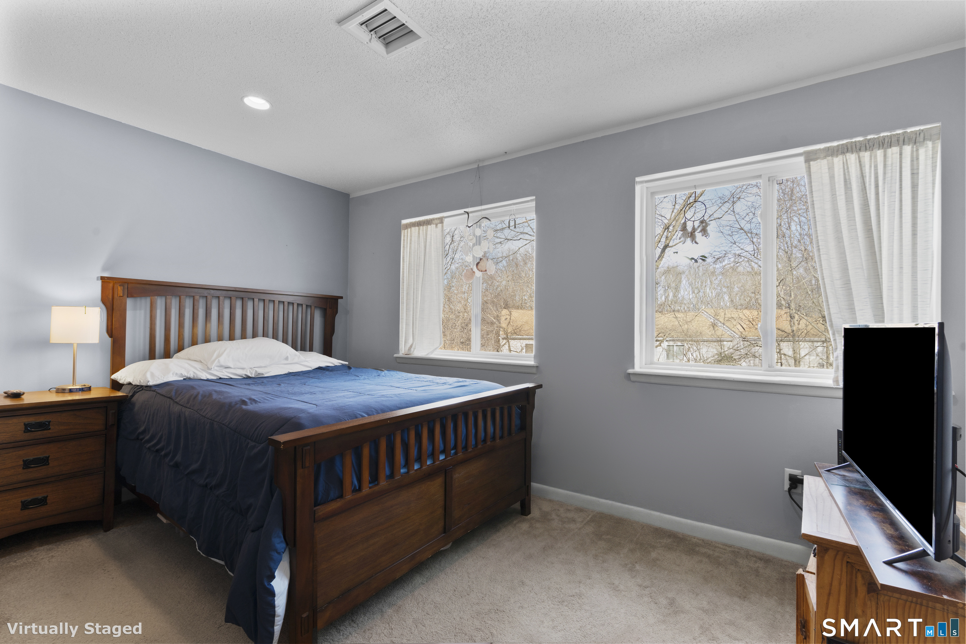 3 MacIntosh Lane, Unit 3 Ansonia, CT 06401 - Photo 21 of 34 a bedroom with a bed window and a flat tv screen on a dresser