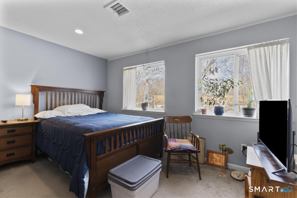 3 MacIntosh Lane, Unit 3 Ansonia, CT 06401 - Photo 22 of 34 a bedroom with a bed and a tv