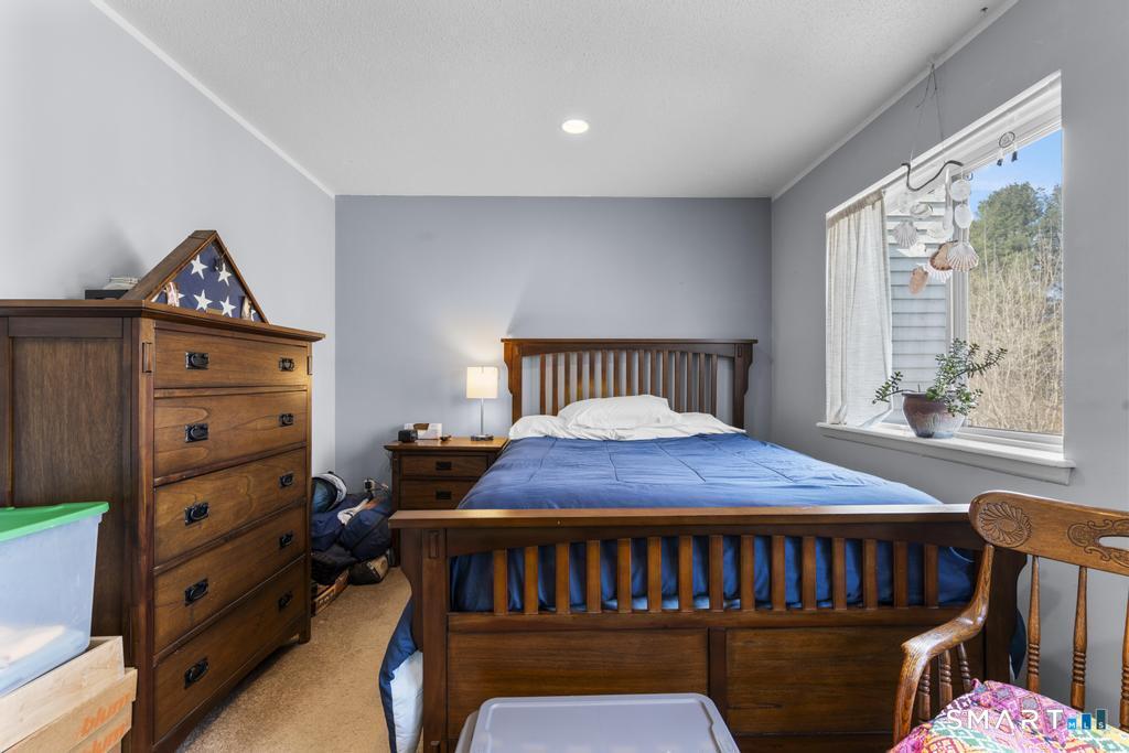 3 MacIntosh Lane, Unit 3 Ansonia, CT 06401 - Photo 23 of 34 a bedroom with a bed and wooden floor