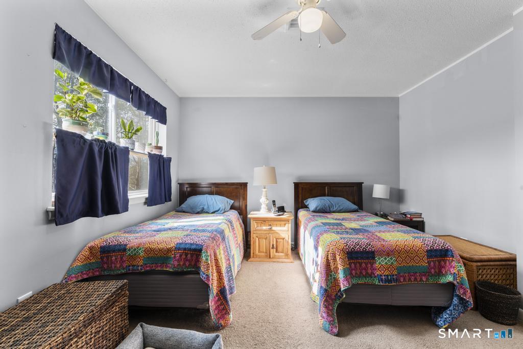 3 MacIntosh Lane, Unit 3 Ansonia, CT 06401 - Photo 24 of 34 a bedroom with a bed and a chandelier
