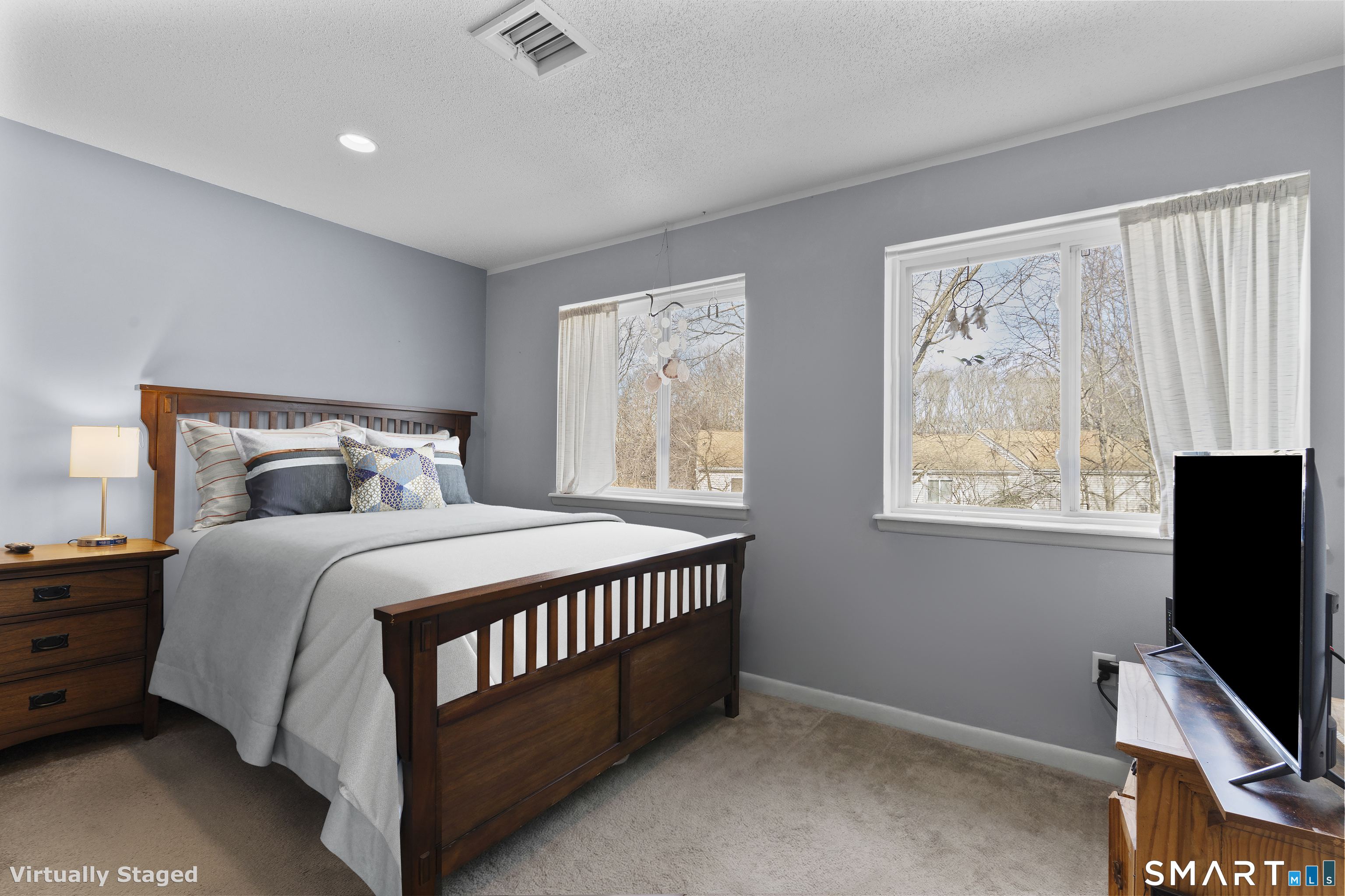 3 MacIntosh Lane, Unit 3 Ansonia, CT 06401 - Photo 25 of 34 a bedroom with a bed window tv and flat screen tv