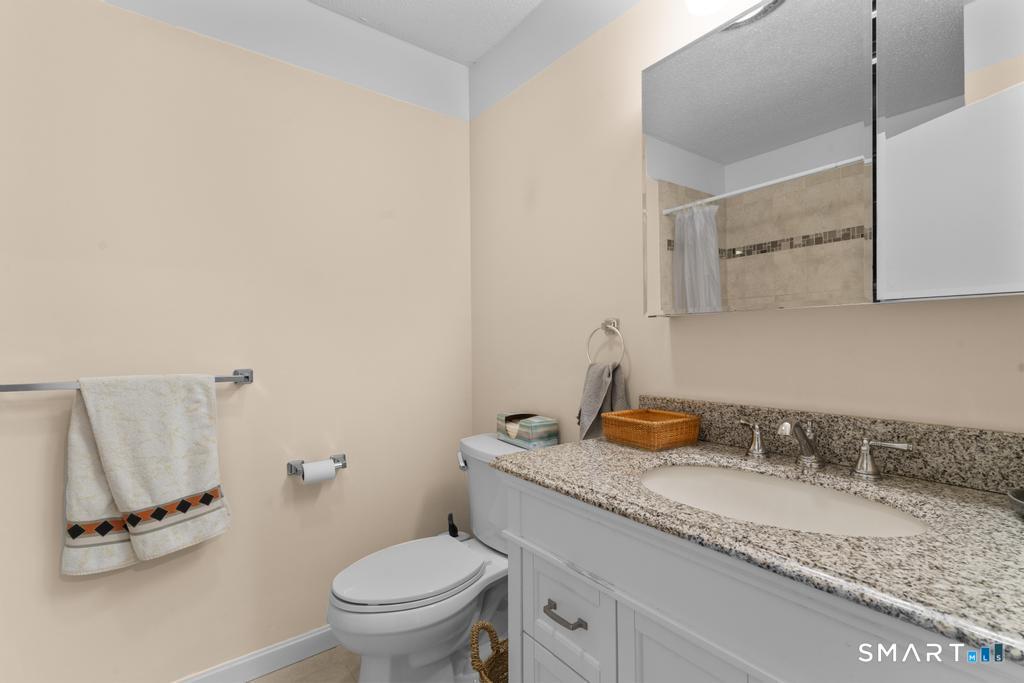3 MacIntosh Lane, Unit 3 Ansonia, CT 06401 - Photo 26 of 34 a bathroom with a granite countertop sink and a mirror